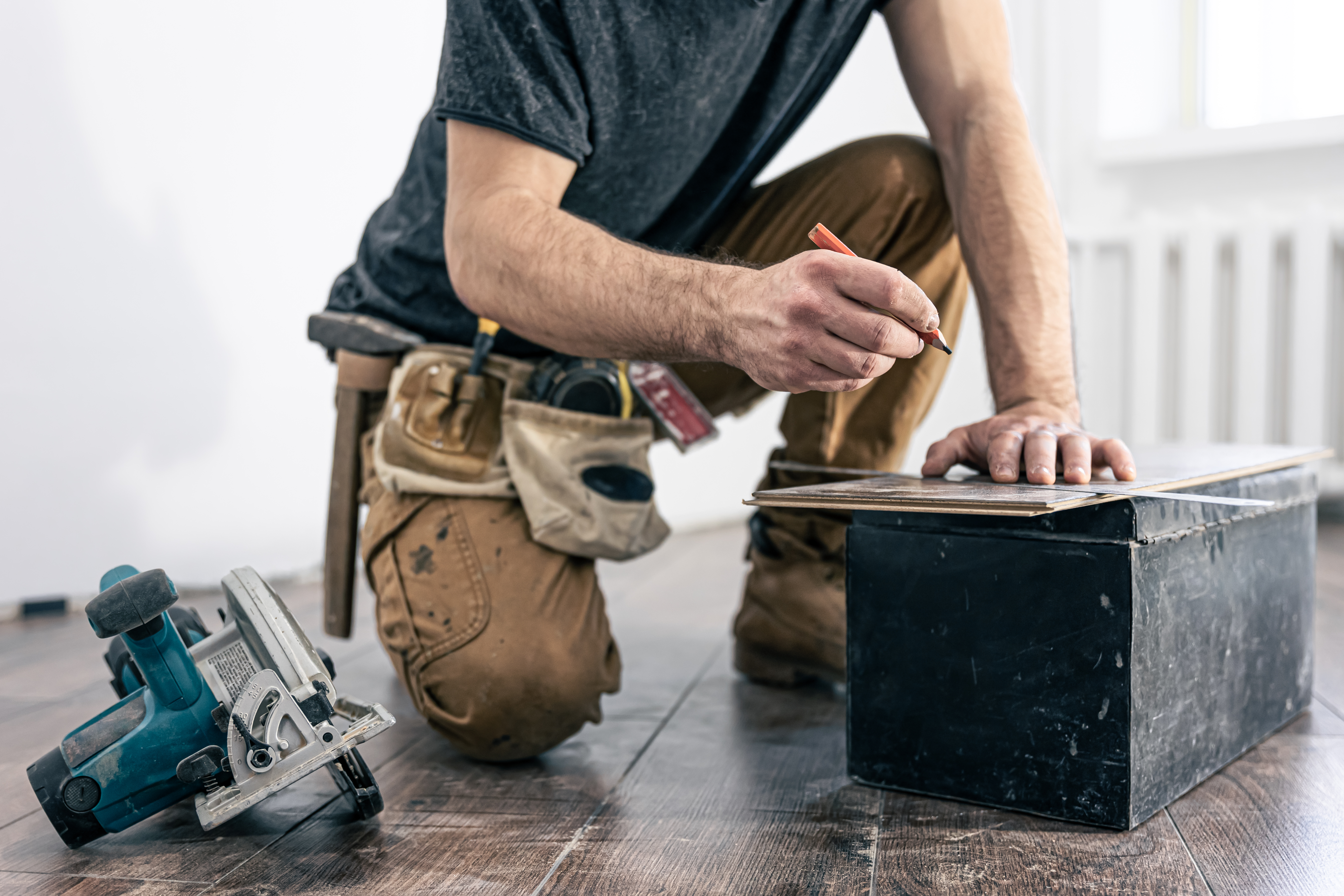 Tradesperson using saw on site
